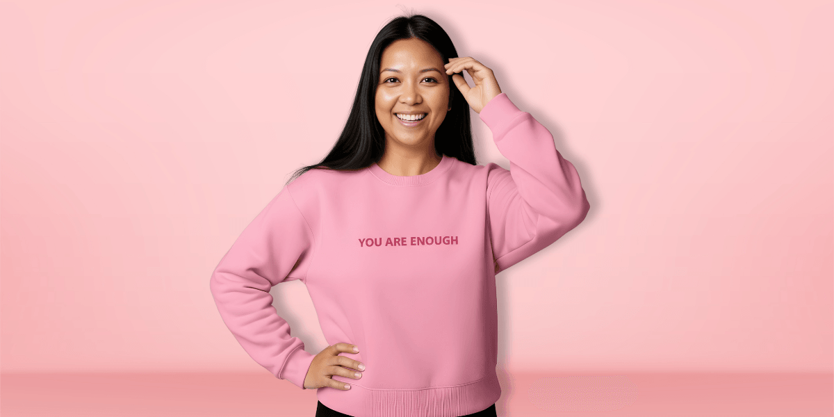 "Ara Jaingue, founder of Mama Tribe United, speaking at an event, promoting healing through science-backed affirmation apparel for mothers."