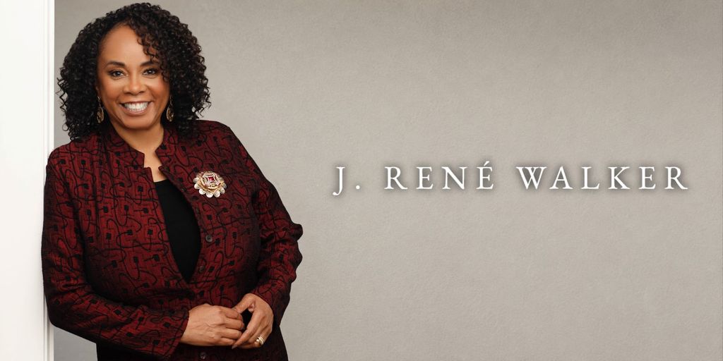 J. René Walker smiles in a burgundy jacket beside her name on a neutral background.