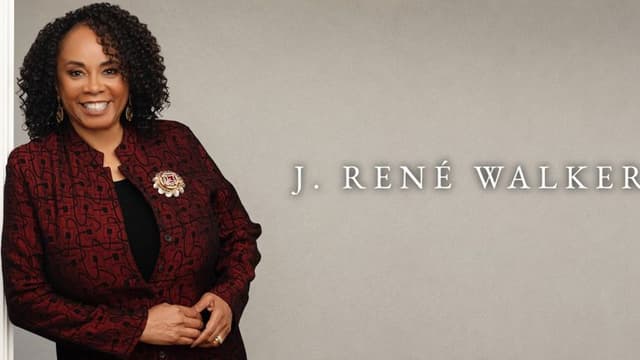 J. René Walker smiles in a burgundy jacket beside her name on a neutral background.