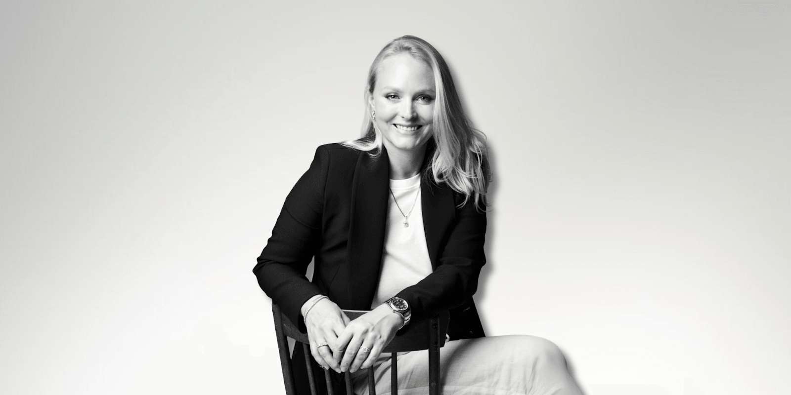 Milena Dold, founder of IRALIS, confidently seated and smiling, embodies the empowerment and luxury of self-purchased diamonds, symbolizing independence, achievement, and a redefined approach to personal milestones in the jewelry industry.